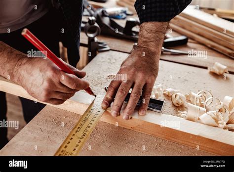 Carpenter makes pencil marks on a wood plank Stock Photo - Alamy