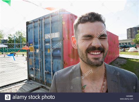 Portrait laughing young brunette man near shipping container Stock Photo - Alamy