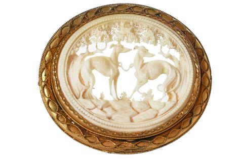 Lot 30 - A finely-carved ivory brooch set in a gilt