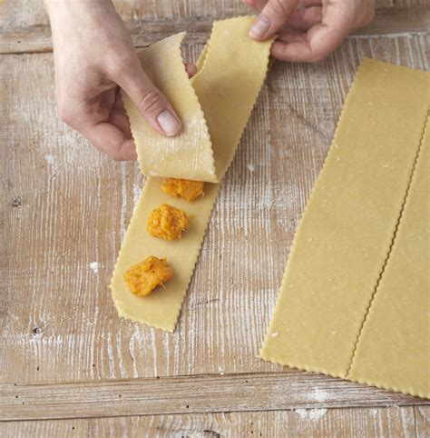 putting second strip over filled ravioli strip | Homemade ravioli ...