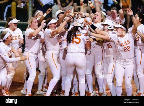 The Texas longhorns Womens Softball Team Celebrates Courtney Day's Home Run at Home Plate Stock ...