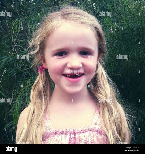 Little smiling girl missing two front teeth Stock Photo - Alamy