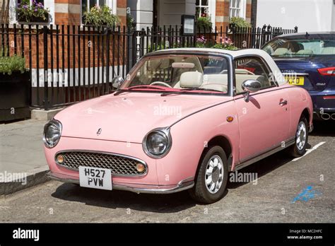 A pink Nissan Figaro car Stock Photo - Alamy