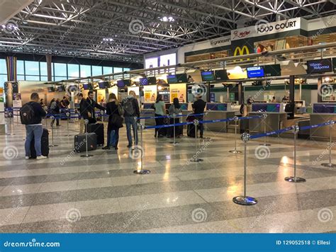 Passengers Lined Up For Chek-in Inside The Milan-Malpensa Airport Terminal 1. Editorial Photo ...