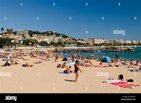 People sunbathing on the beach at Cannes, France Stock Photo - Alamy