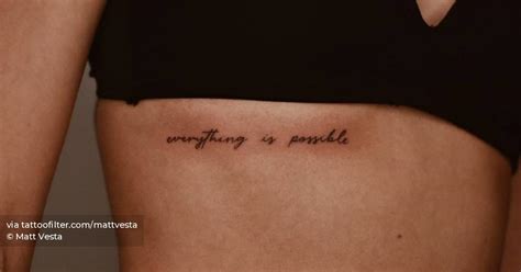 "Everything is possible" lettering tattoo on the rib.