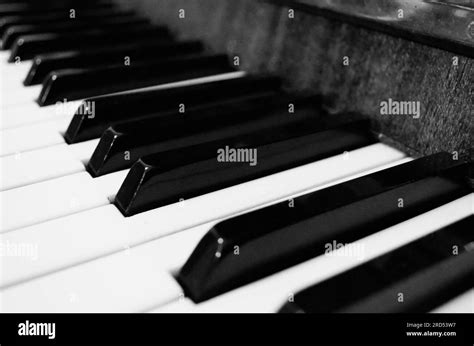Black and white piano keyboard. Piano keyboard monochrome close-up picture. Retro style picture ...