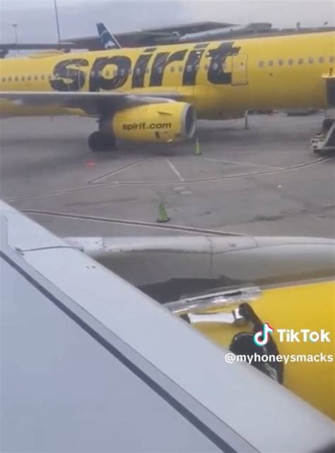 Stunned airline passenger watches worker putting tape on plane wing ...