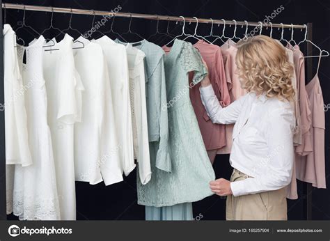 Woman choosing clothes in clothing store — Stock Photo © AllaSerebrina ...