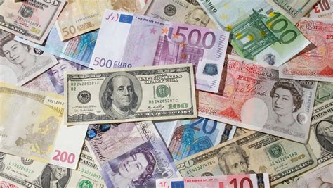 Download A Pile Of Different Currency Notes | Wallpapers.com