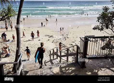 Crowds of people enjoying sunbathing, surfing and life on Noosa Main ...