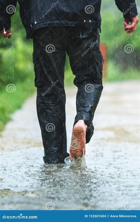 A Man in the Rain is Barefoot in Puddles Stock Photo - Image of feet, city: 152601604