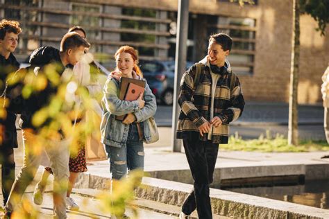 Group of friends walking outside college. Students walking together ...