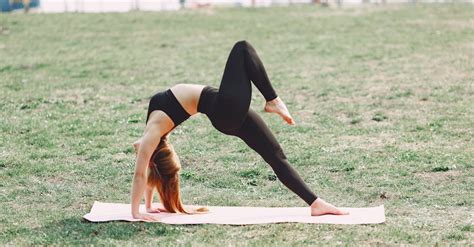 Flexible barefoot woman performing yoga pose on green lawn · Free Stock ...