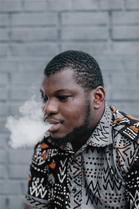 "Black Man Smoking" by Stocksy Contributor "Julia Volk" - Stocksy