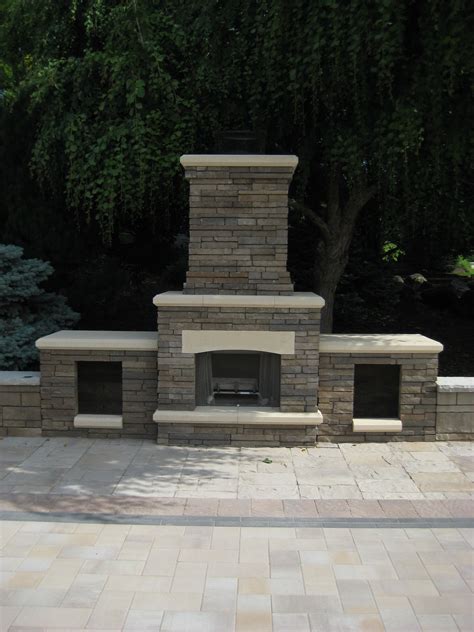 Belgard Bordeaux fireplace with wood boxes. With Belgard pavers in the ...