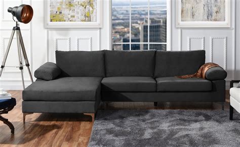 a living room with a gray couch and white chair