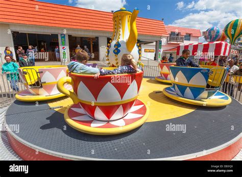 Children and parents enjoy the amusement park rides Stock Photo - Alamy