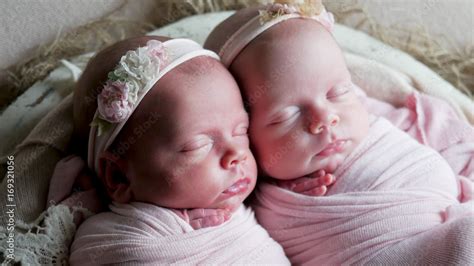 twin babies sleep in the crib in dresses and headband Stock Photo ...