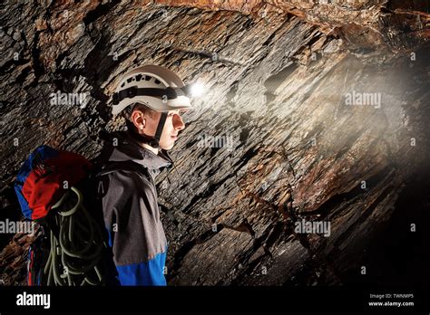 Young speleologist exploring a cave Stock Photo - Alamy