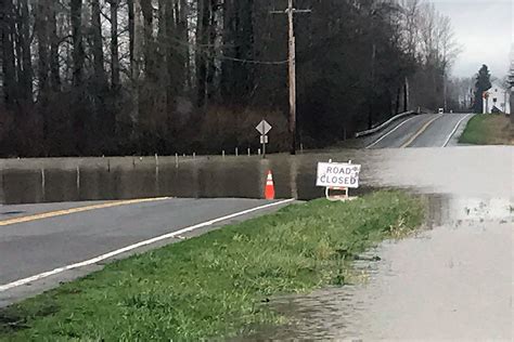 Flooding closes roads in Arlington, Stanwood; snow in store ...