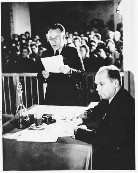 A member of the prosecution team reads a statement at the Sachsenhausen ...