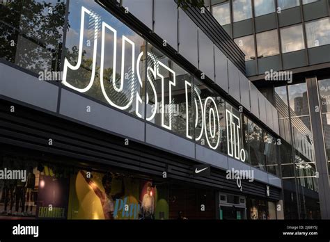 Nike slogan "Just do it." on the wall of a store. Illuminated letters ...