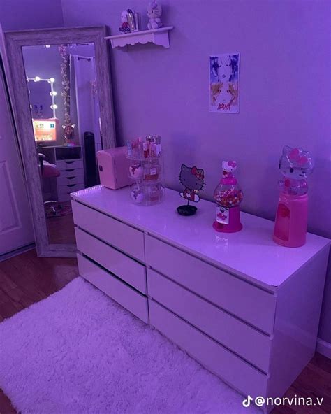 a white dresser with hello kitty decorations on it