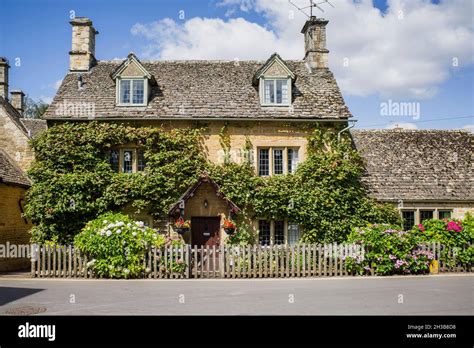 A pretty chocolate box cottage made from Cotswold stone, with a slate ...