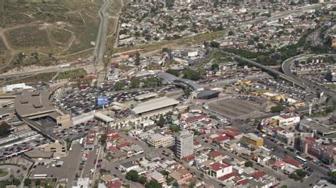 Approach Heavy Border Traffic Tilt Down, US/Mexico Border Tijuana Aerial Stock Footage DCA08_063