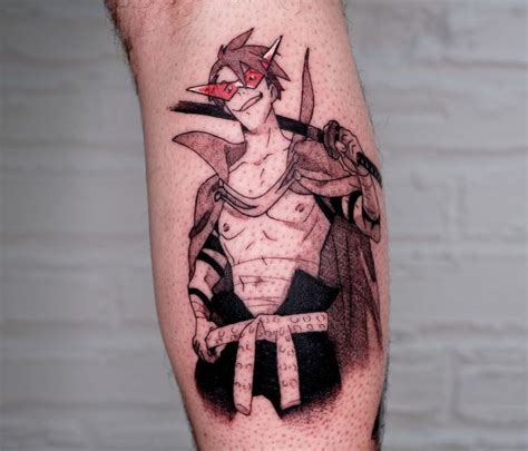 a man's leg with a tattoo on it that has an image of a bird holding two swords