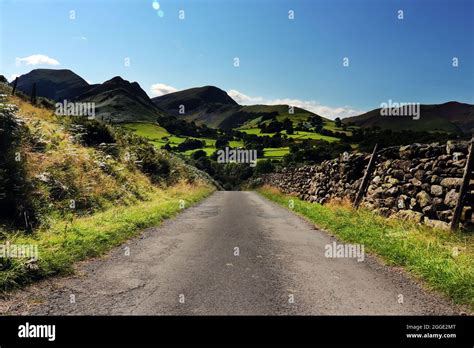 Road leading to mountains Stock Photo - Alamy