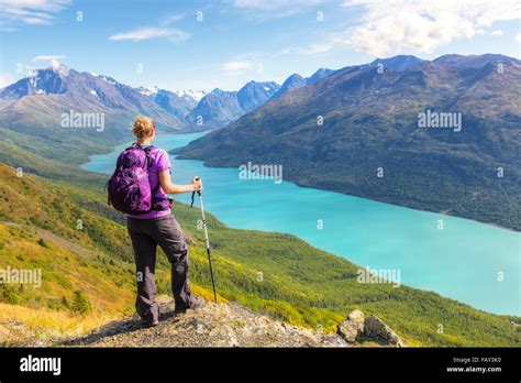 Female hiker overlooking Eklutna Lake from Twin Peaks Trail, Chugach State Park, Southcentral ...