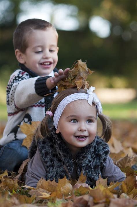 Kids playing with leaves stock image. Image of golden - 27317859