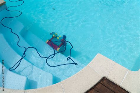 Robot cleaning swimming pool Stock Photo | Adobe Stock