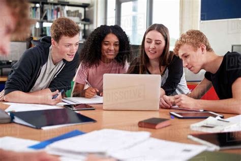 Group Of College Students Collaborating On Project In Library - Stock Photo - Dissolve