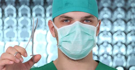 Close Up of Medical Doctor Man Wear Surgical Mask Show Scissors in ...