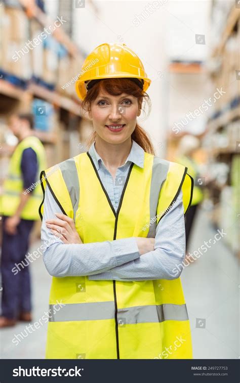 Warehouse manager smiling at camera with arms crossed in a large warehouse #Ad , #Advertisement ...