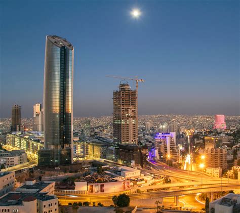 Top view of the new downtown of Amman at night with moon - Travel Off Path