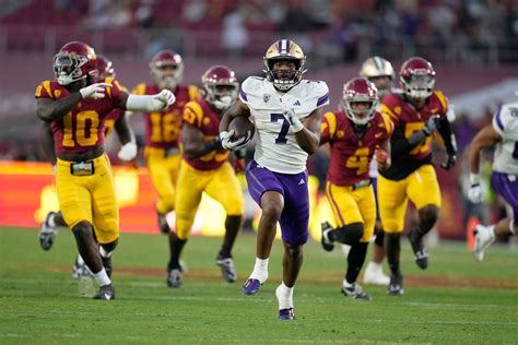 Johnson runs for 256 yards, 4 TDs in No. 5 Washington's high-octane 52-42 win over No. 24 USC ...