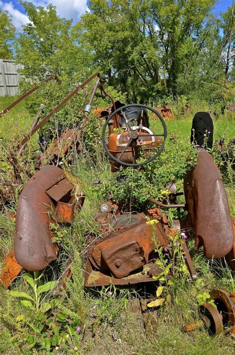 An Old Rusty Tractor is Buried in Green Foliage Stock Photo - Image of ...