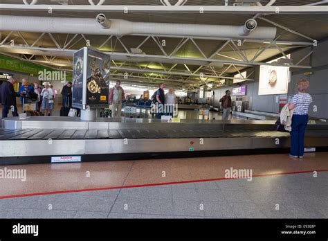 Arrivals waiting for luggage carousel at Jersey Airport The Channel ...