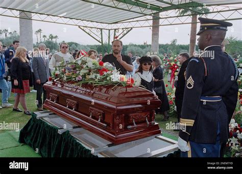 A mourner places arose on the casket of Congressman Sonny Bono, Friday ...