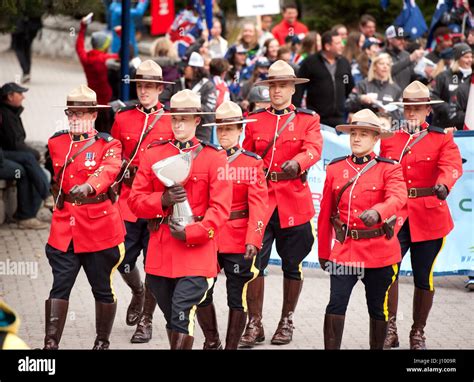 Royal Canadian Mounted Police, or RCMP officers in traditional dress red serge uniforms parade ...