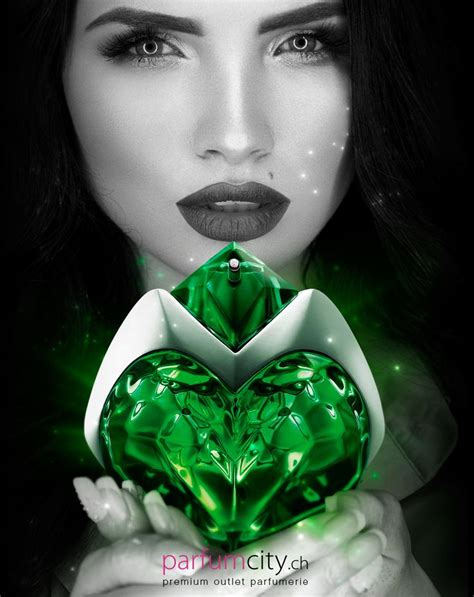 a woman holding a green heart in her hands