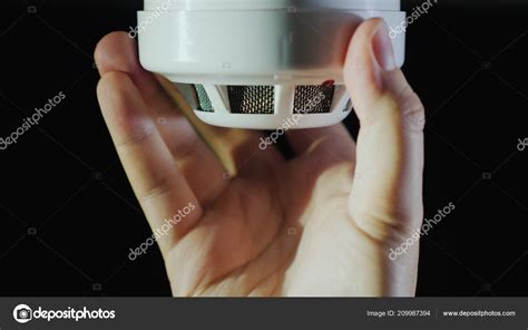 Man installs a sensor fire protection system Stock Photo by ©StockSeller 209987394