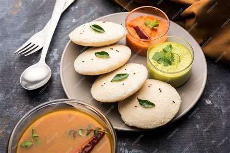 Premium Photo | Idly sambar or Idli with Sambhar and green, red chutney ...