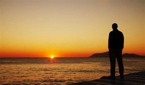 Man looking on sunset stock photo. Image of beach, orange - 2212584