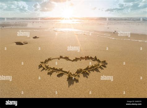 Heart in the sand beach Stock Photo - Alamy