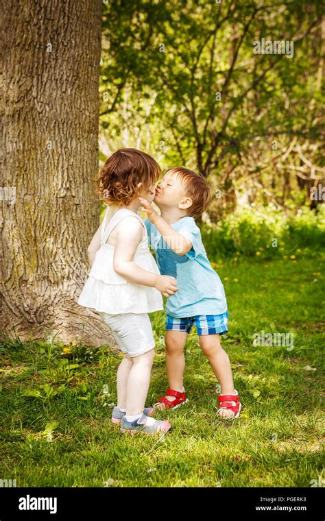 Portrait of two cute adorable baby children toddlers hugging and ...